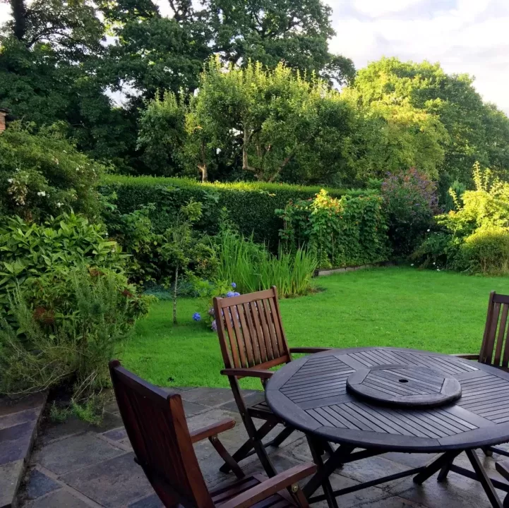 wooden chairs and table in completely green lawns royalty free i